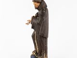 a statue of a man in a black robe holding a blue ball