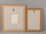 two framed pictures of a couple of wooden frames on top of a table