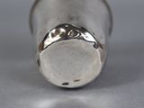 a close up of a silver object on a table