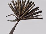 a close up of a metal object with nails on it