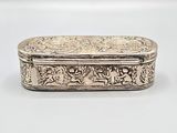 a silver box with a design on the lid