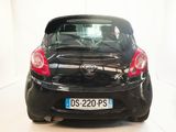 a picture of a small black car parked in a room