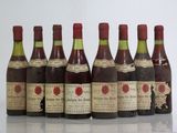 six bottles of wine are lined up in a row on a table