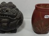 two vases sitting next to each other on a table
