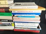 many books stacked on top of each other on a table