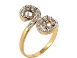 a close up of a gold and diamond ring on a white background