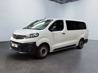the small white van is parked in a large room