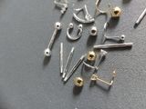many different types of ear piercings laying on a table