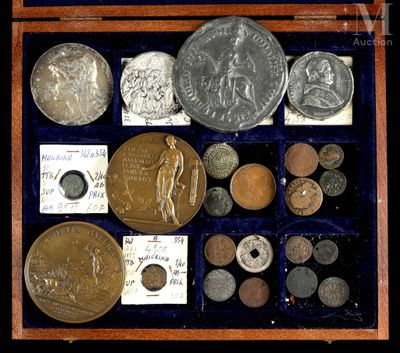 a wooden box with a variety of coins in it