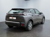 the rear of a grey car is parked in a garage