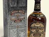 bottle of chivas regal whisky next to a box on a table