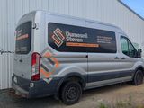 a van parked in front of a building with graffiti on it