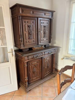 a large wooden cabinet in the corner of a room