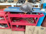 a workbench with tools and a hard hat on it