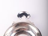 an old silver plate with a handle on a white background