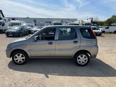 a silver car that is parked in a parking lot