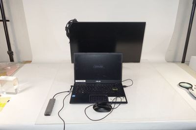 a laptop computer sitting on top of a white table