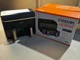 a black and orange printer sitting on a counter next to a black and white printer