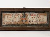 an image of a wooden box with a painting of a man and two cows