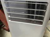 un petit climatiseur posé par terre