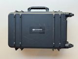 a black case sitting on top of a white wall