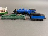 three toy trains sitting next to each other on a table