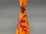 a vase with a bird design on it sitting on a table