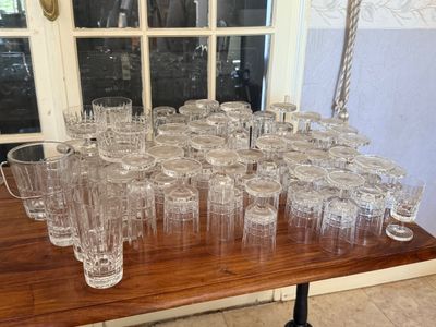 a lot of empty glasses on a table in front of a window