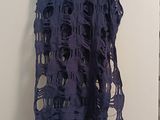 a purple scarf hanging on a wall in a room