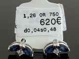 a close up of a pair of earrings with a price tag