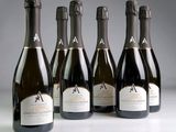 six bottles of champagne are lined up on a table