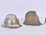 two helmets sitting next to each other on a white surface