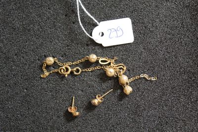 un collier et une boucle d'oreille posés sur une table, avec une étiquette de prix