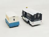 two toy vehicles that are next to each other on a white surface