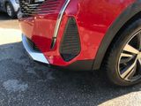 a close up of a red car parked in a parking lot
