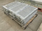 several pieces of metal are stacked on top of pallets in a warehouse