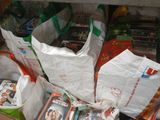 many bags of food and magazines on the floor