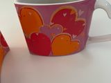 a cup and spoon sitting next to each other on a table