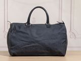 a black handbag sitting on top of a wooden table