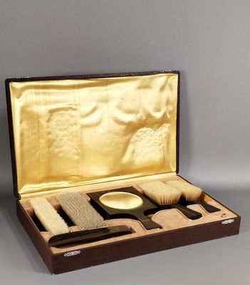 une boîte en bois contenant une brosse, un peigne et d'autres objets