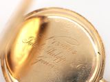 a close up of a pocket watch with a pen in it