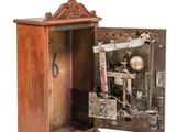 a small wooden box with a clock inside of it