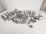 a lot of silver figurines sitting on a white surface