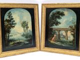 two framed paintings of a landscape with a man and woman on a bridge