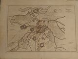 an old map of a town on a piece of paper on a table