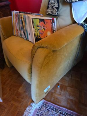 a chair that has a lot of books on it