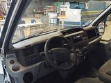 a dashboard and steering wheel of a vehicle in a garage