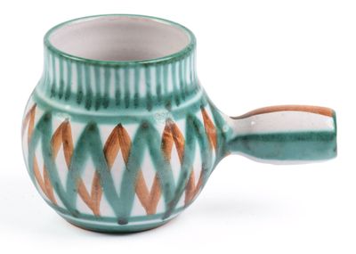a cup with a handle on a white surface