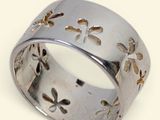 a close up of a silver ring with flowers on it