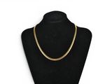 a black mannequin with a gold chain on it